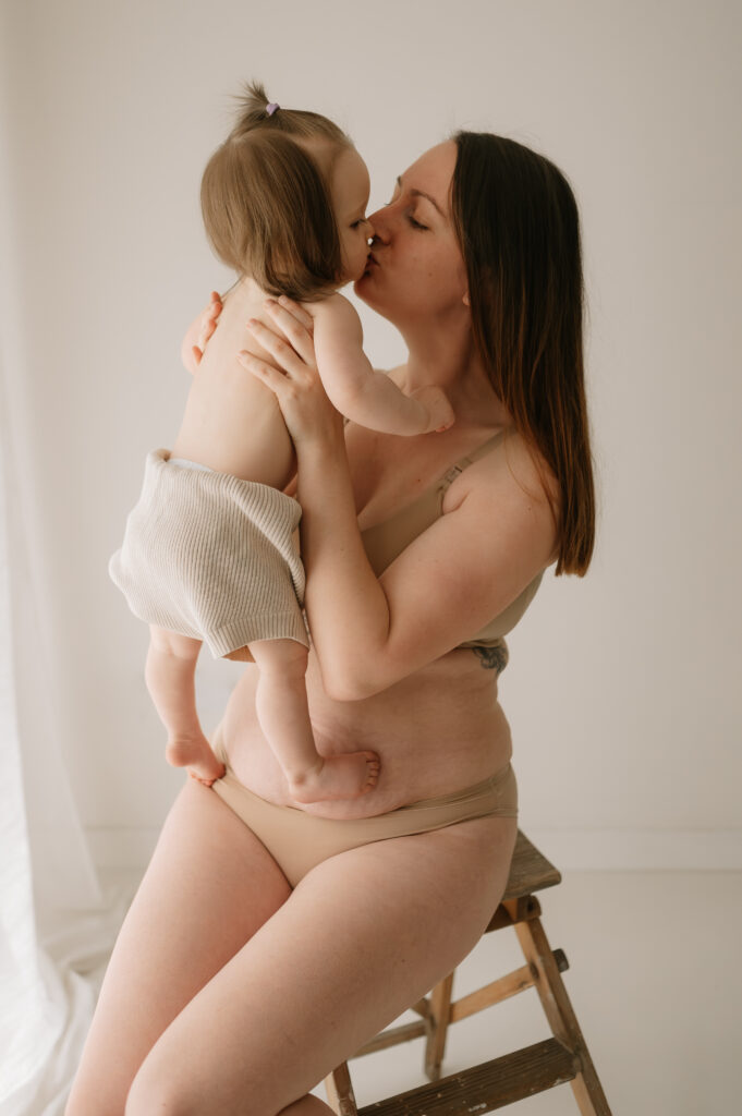 mum kissing her baby girl in york studio