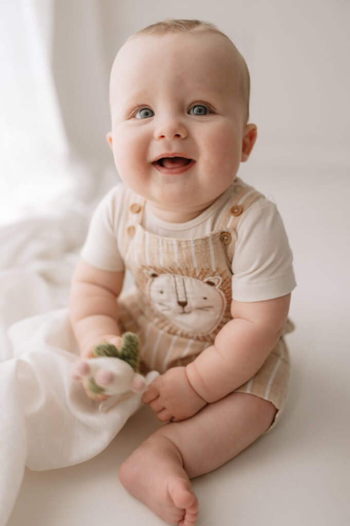 baby boy smiling at the camera in york photography studio