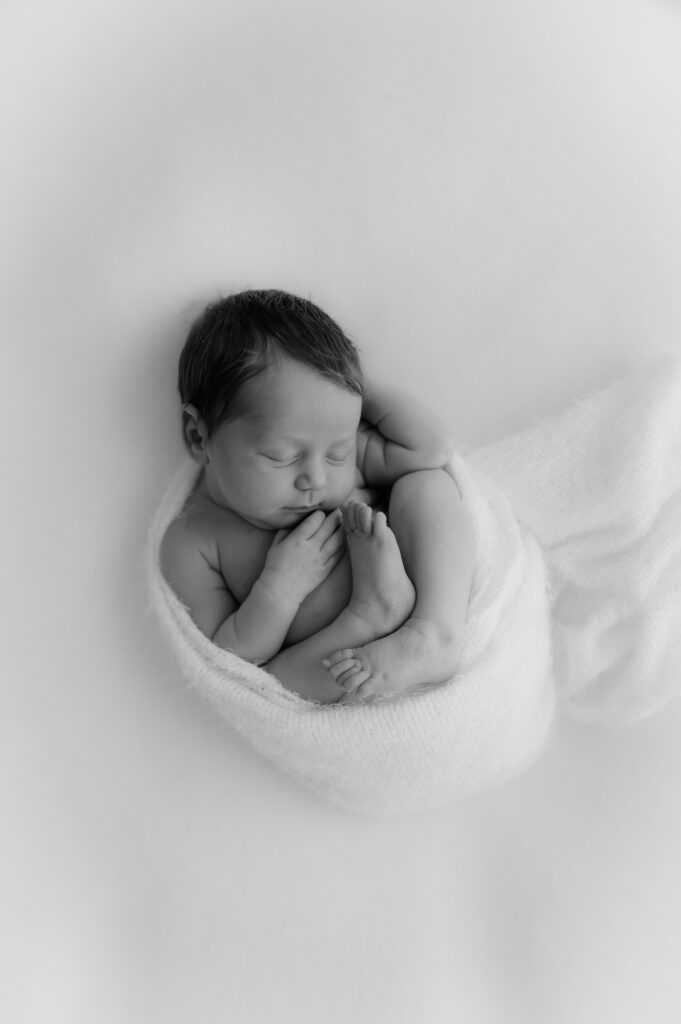 newborn baby girl wrapped up at her newborn photoshoot in york