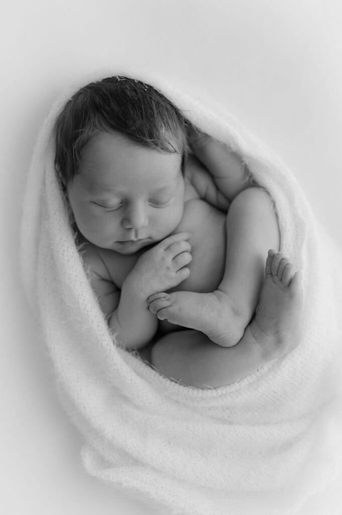 newborn baby girl wrapped up at her newborn photoshoot in york