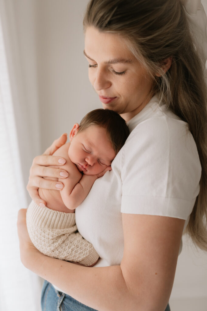 newborn baby girl on her mum and dad